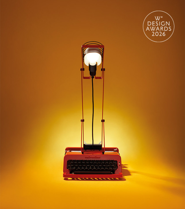 Red Sintesi lamp on a yellow background, photographed by Pierpaolo Ferrari, featuring a red Valentine typewriter and the Wallpaper* Design Award logo.