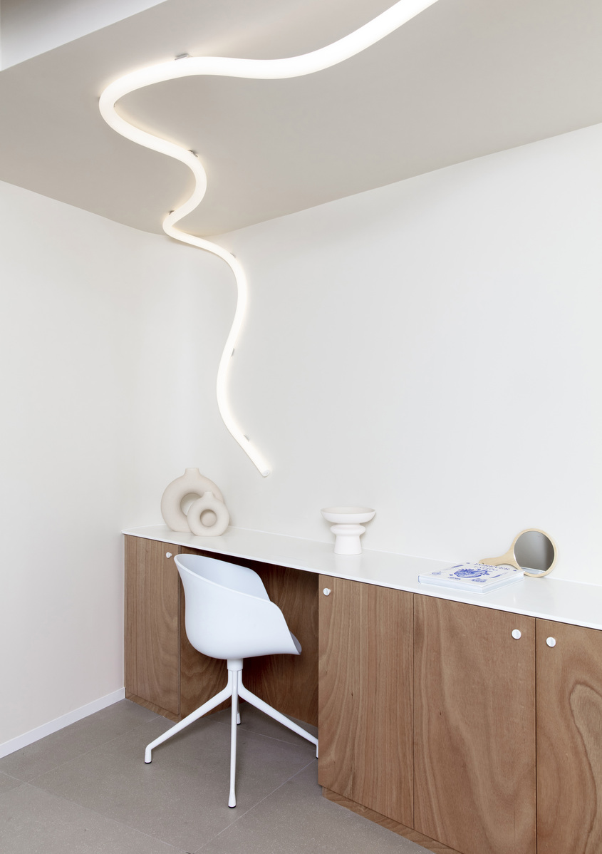 Immagine della stanza dello studio illuminata con La linea che dal soffitto correndo arriva fino alla parete.